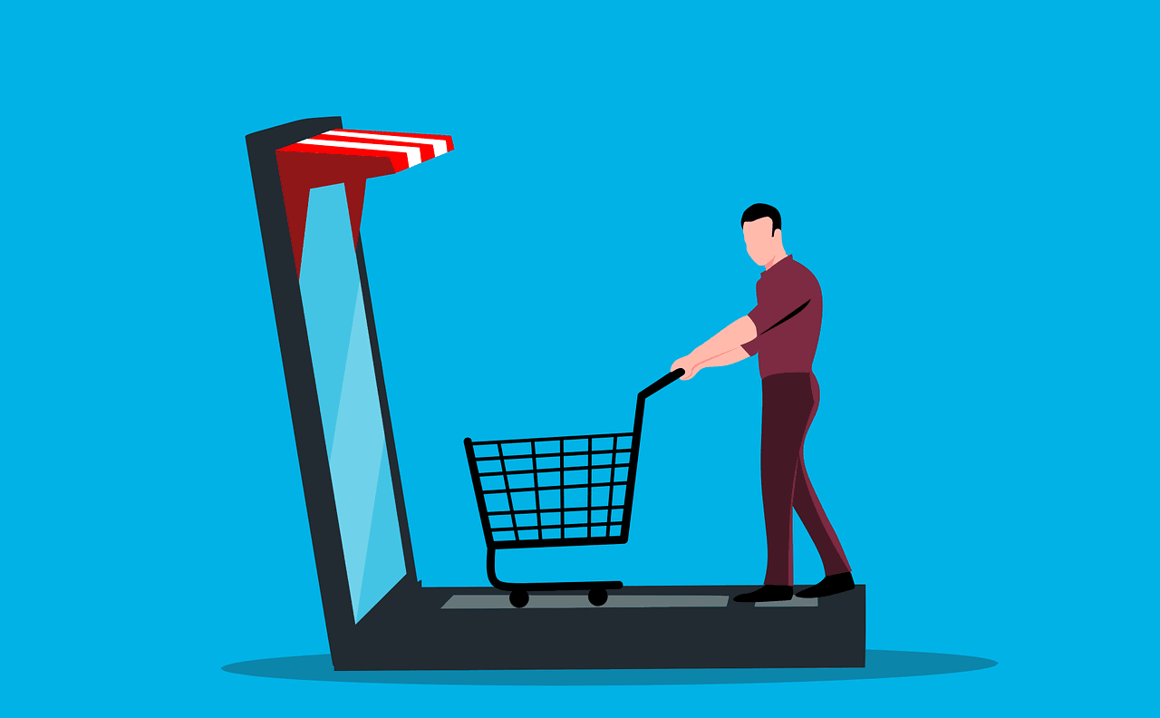 laptop-5820171_1280 Man shopping online using a laptop with a shopping cart emerging from the screen.