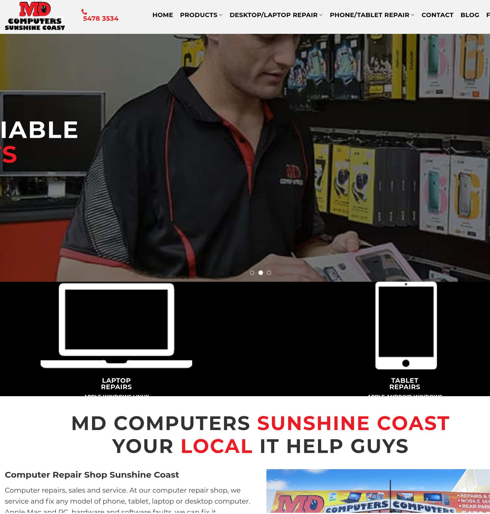 Laptop and tablet repair technician working on a device in a tech store.